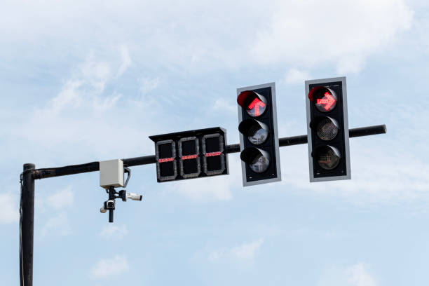 istock Red arrow icon on traffic light pole with blue sky background 1622308792