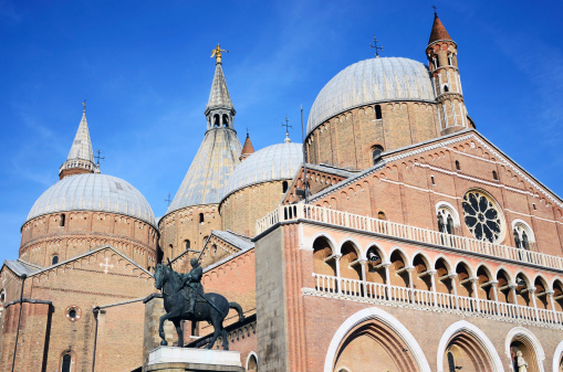 Statue of Erasmo da Narni on Basilica of St. Anthony background, Padua, Italy. Completed in 1450 by Donato di Niccolo di Betto Bardi (1386 – 1466), also known as Donatello, and placed in the square facing the Basilica of St. Anthony, his equestrian statue of Erasmo (better known as the Gattamelata, or \
