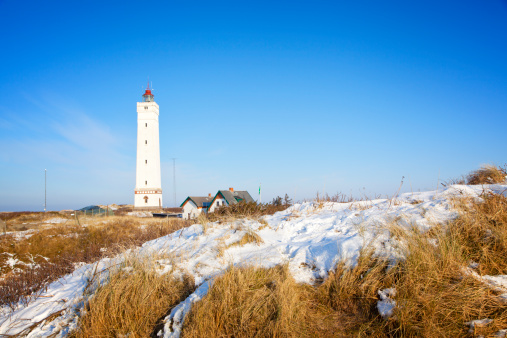 View on Kampen and river IJssel in winter in Holland. Kampen is an ancient Hanseatic League in Overijssel, The Netherlands. The New Tower and city bridge are  visible in the foreground of the city.