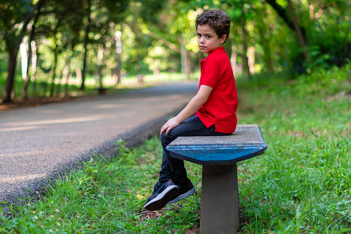 Boy sitting on a park bench