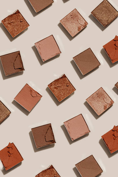 Beauty product neutral color eyeshadows for makeup, beige monochrome pattern on light background, flat lay with nude colors swatches eyeshade, cosmetic texture, beige color palette, top view pattern