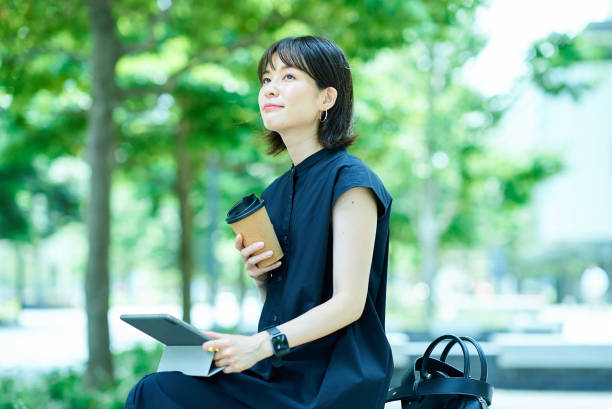 Woman drinking coffee on the street corner