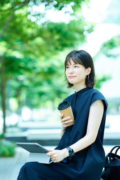 istock Woman drinking coffee on the street corner 1622334497