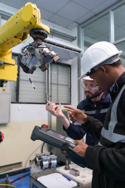 istock Multiracial tachnicial engineer training with robot arm 1622336144