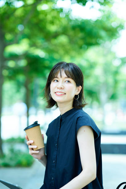 istock Woman drinking coffee on the street corner 1622337236
