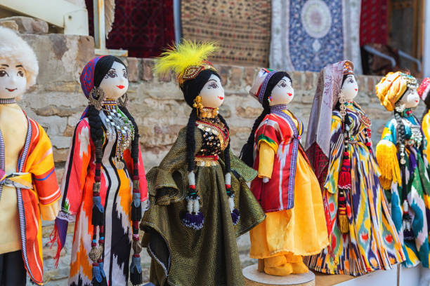istock Dolls dressed in traditional uzbek costumes. Traditional souvenir puppet from painted mashed paper (papier mache). Close up, selected focus. Bukhara (Buxoro), Uzbekistan. Souvenir and gift concept 1622337785