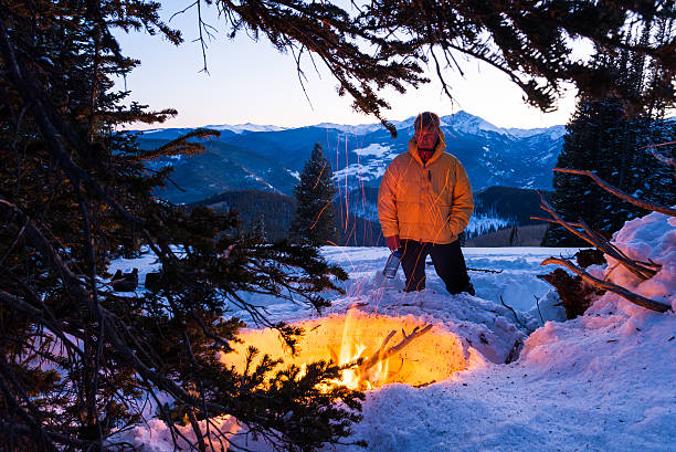 Photo of Man Warming Up in Winter by Fire