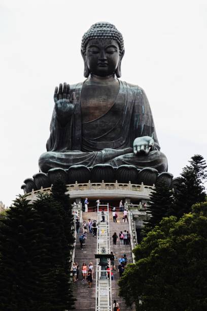 istock people standing around a large statue at the base of a hill 1622374678