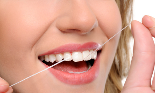 young woman mouth flossing teeth.