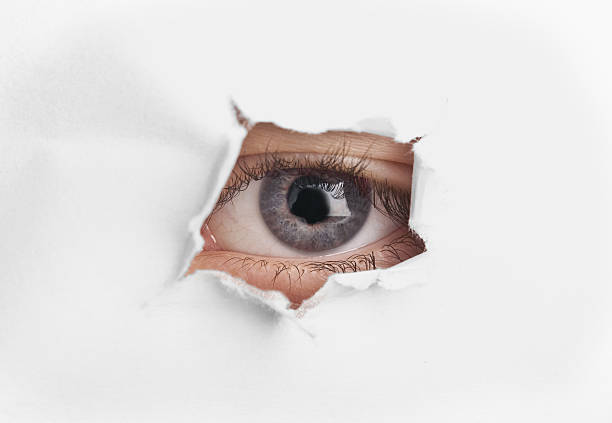 istock Eye look trought paper hole 162238934