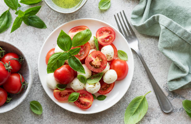 Caprese salad with tomatoes, mozzarella and basil. Caprese salad with tomatoes, mozzarella and basil. Healthy food. caprese salad stock pictures, royalty-free photos & images