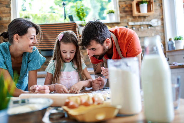 istock Positive family making cookies together 1622427807