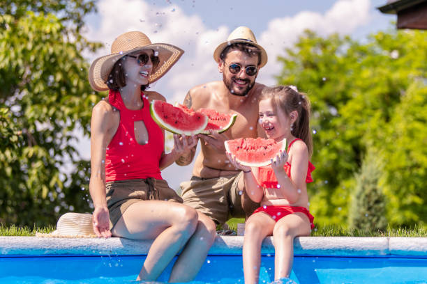 istock Young family enjoying in watermelon 1622431031