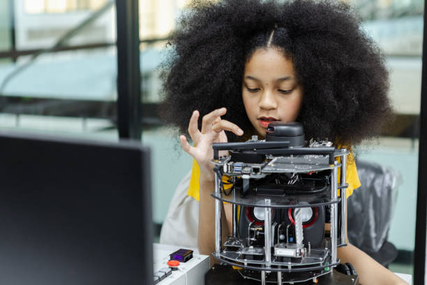 istock Girl with afro hairstyle education electronic on table at class room. learning innovation electronic for future AI. electric system skill training. STEM education concept. 1622439913