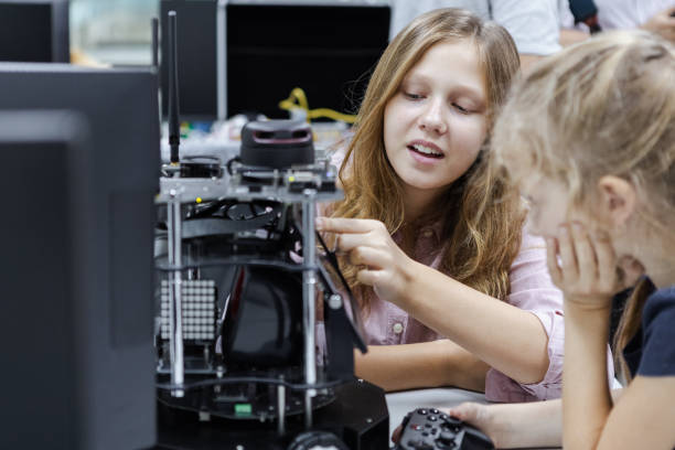 istock Girl Caucasian education electronic robotic on table at class room. learning innovation robot electronic for future AI. System skill training. STEM education concept. 1622447175