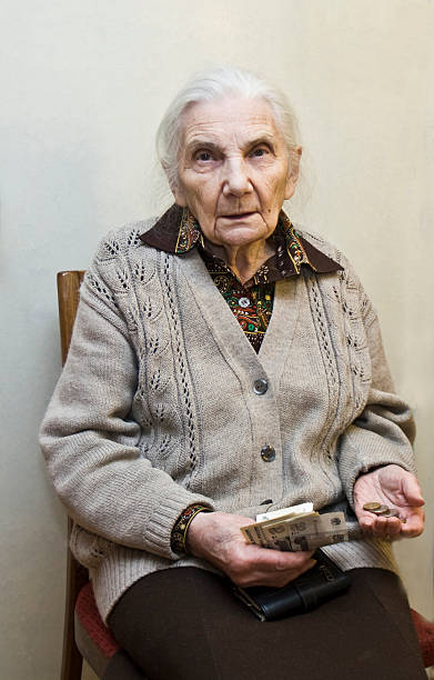 istock Old woman with money in hands 162245329