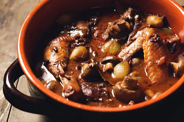 Front view of a pot with French coq au vin - basically a chicken stew.