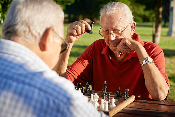 istock Active retired people, two senior men playing chess at park 162245691