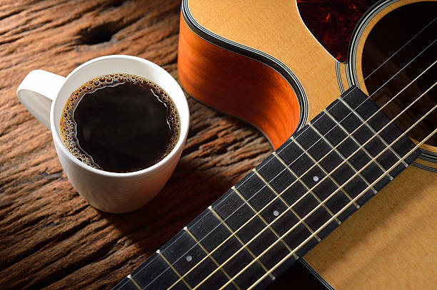 istock Fresh brewed cup of coffee next to a guitar 162247180