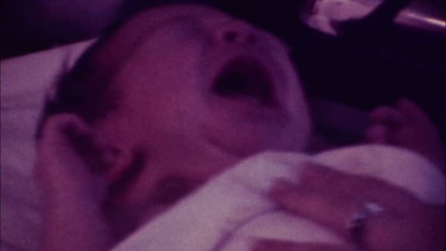 8mm footage - 70's- infant crying while being bathed
