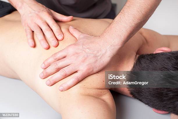 Back Massage Given To A Young Man Stock Photo - Download Image Now - Activity, Alternative Medicine, Back