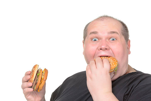 istock Fat Man Greedily Eating Hamburger 162247410