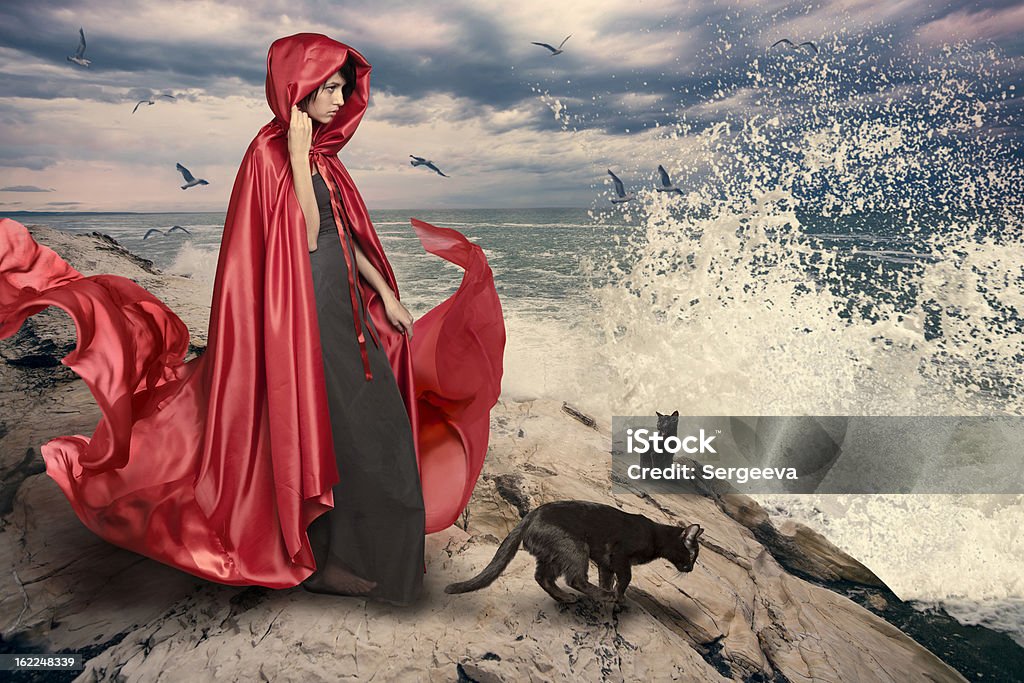 Woman at the sea Photo compilation. The individual elements are added. A woman in a red coat at the sea. Witch Stock Photo