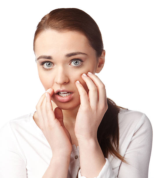 Surprised young woman looking at you stock photo