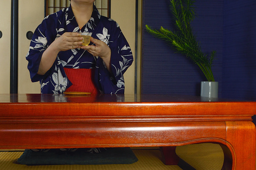 Woman Having A Cup of Green Tea in the Japanese Traditonal Room/Studio Shot