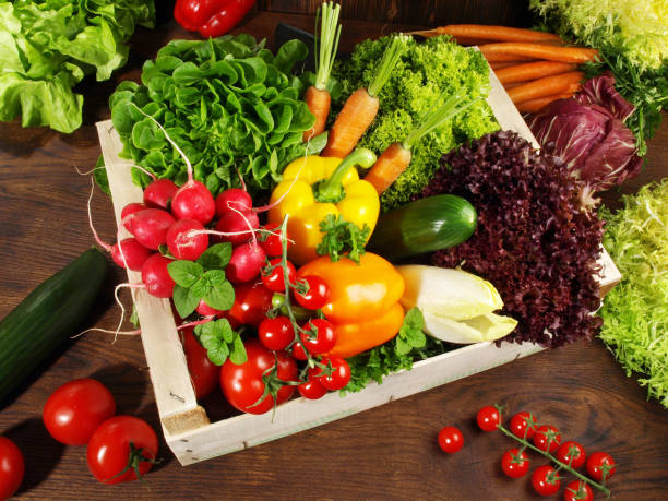 istock Mixed Vegetables and Salads in a Box on wooden Background 1622498037