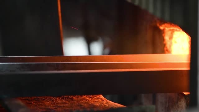 Blacksmith manually forging the molten metal
