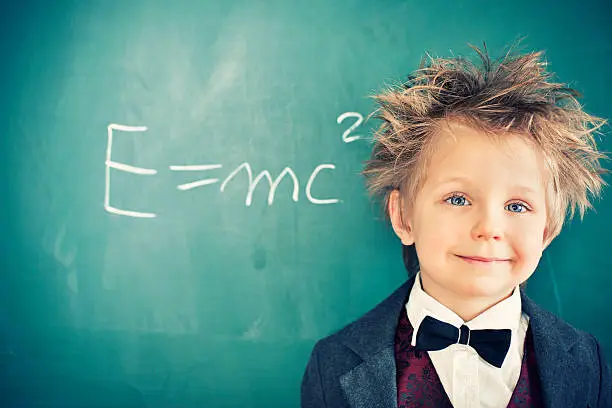 Cute little boy with messy hair rediscovering the famous equation E=mc2