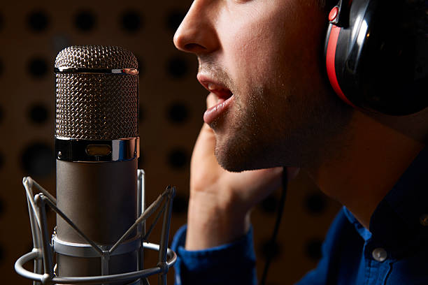 istock Male Vocalist Singing Into Microphone In Recording Studio 162252686