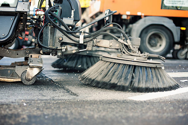 Close-up of a street cleaning truck Close-up of a street cleaning truck - minor motion blur street sweeper stock pictures, royalty-free photos & images