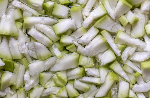Top View of Calabash or Bottle Gourd Diced Pieces in Water for Cleaning, Also Known as Long Melon or White Flower Gourd