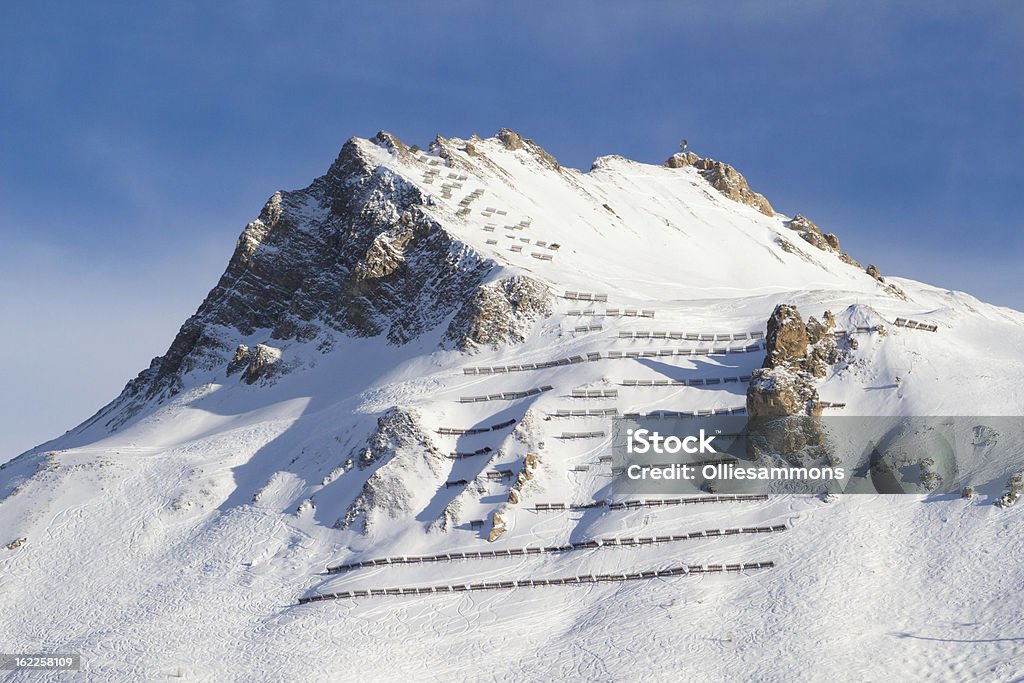 Avalanche Protection Image shows a snow covered mountain in a French ski resort, with Avalanche barriers to protect skiers and snowboarders. Avalanche Stock Photo