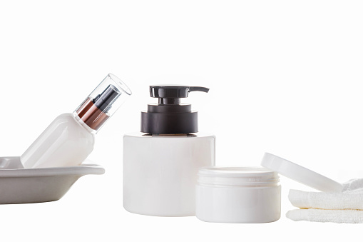 Set of various cosmetic bottles on white background