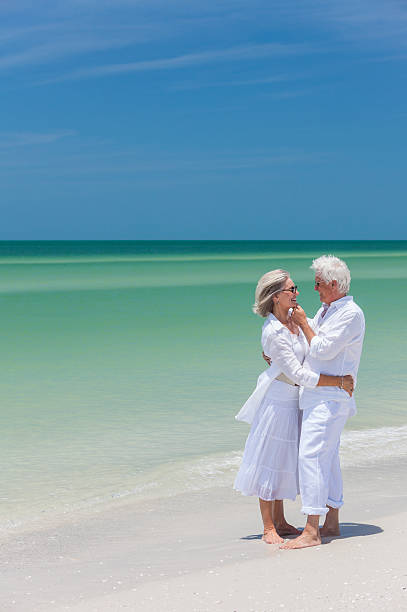 istock Happy Senior Couple Embracing on Tropical Beach 162259207