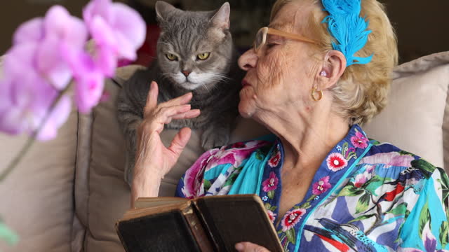 Senior woman and her cat at home.