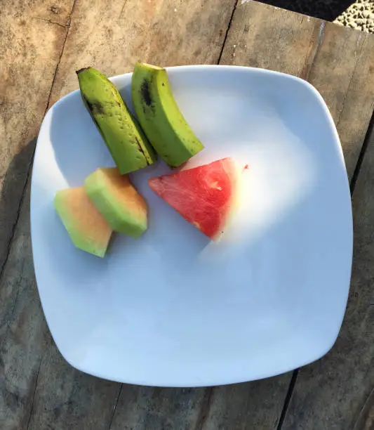 Photo of Plate with tropical fruits prepared for breakfast