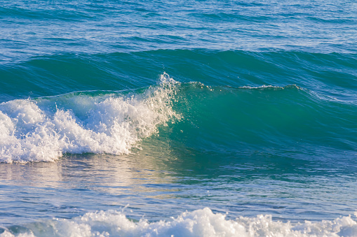 clseup emerald sea vawes near a coast, summer sea bay scene