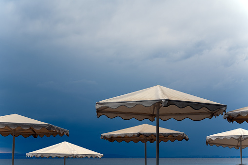 Light umbrellas on a dark blue clouds background