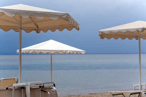 Light umbrellas on an empty beach