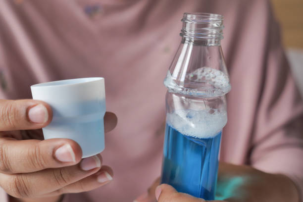 istock women hand hold a mouthwash liquid container 1622629812