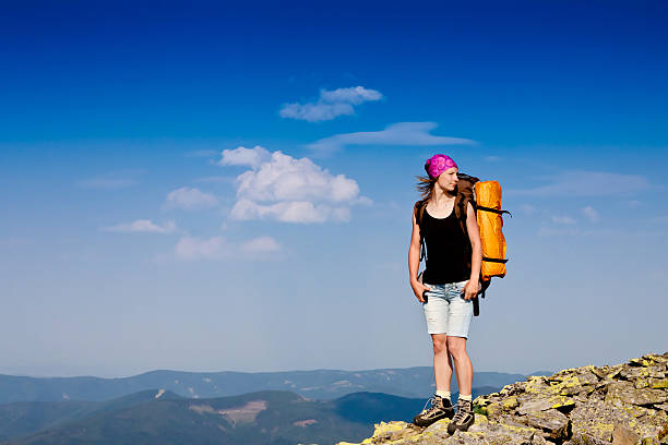istock hiker at the top of a rock 162264480