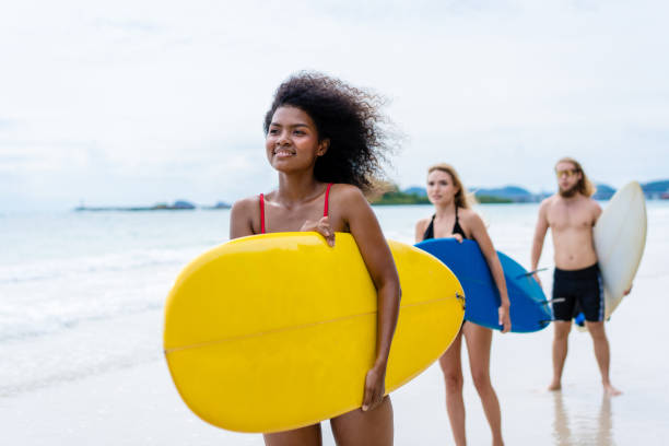 istock Group Friendship playing surfboard on the beach in weekend activity, Sport extreme healthy lifestyle concept. 1622650552