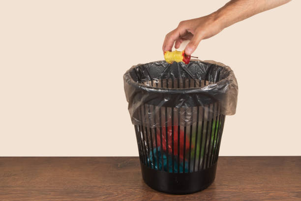 istock Apple core is thrown into trash, food waste. 1622650561
