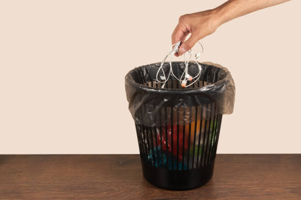 istock Hand throwing old shabby decrepit headphones away, trash bin, electronic waste, goodbye gadget addiction concept 1622650564
