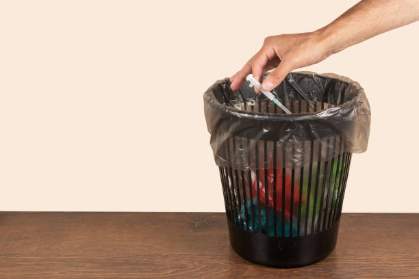 istock Throw medicine trash bottom view expired pills syringe addiction problem modern world 1622650565