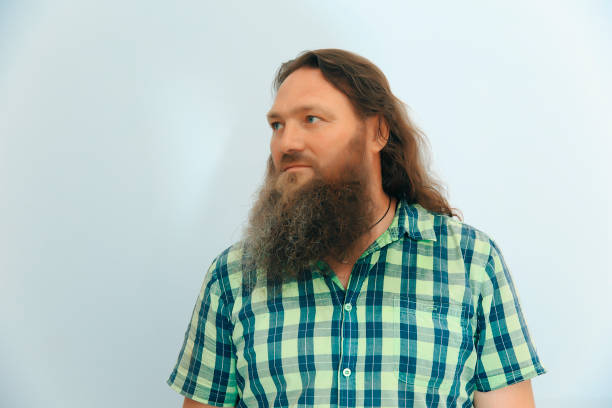 istock Man with a long beard and is waiting for a meeting from the side 1622671421